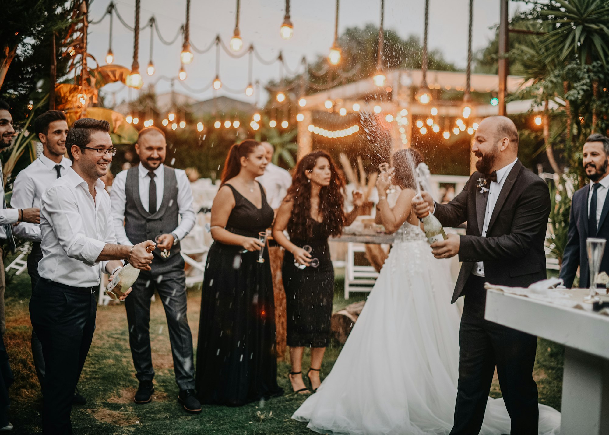Wedding guests celebrating outdoors with champagne